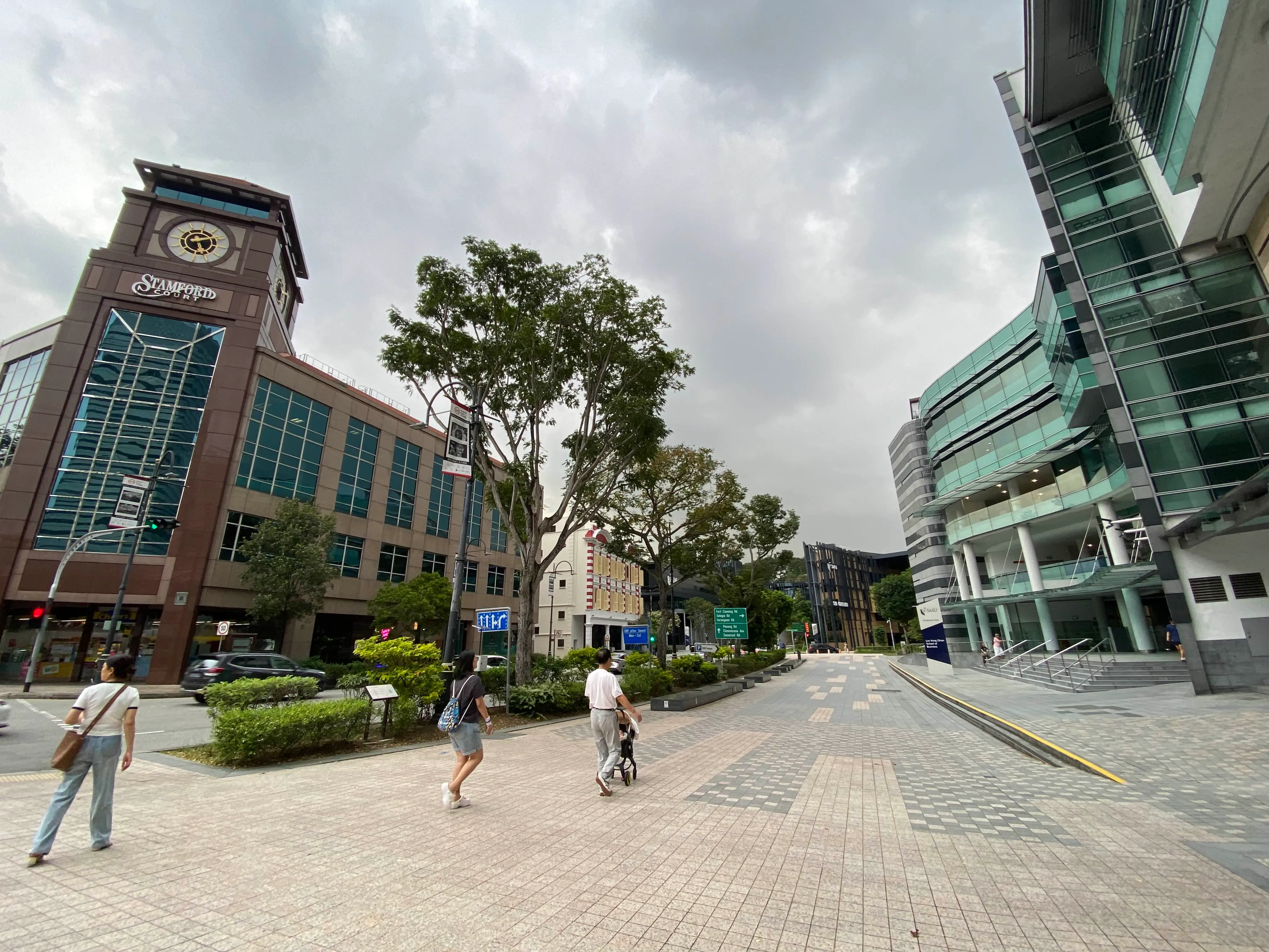 A pedestrian path with Stamford Court on the left and SMU's School of Business on the right