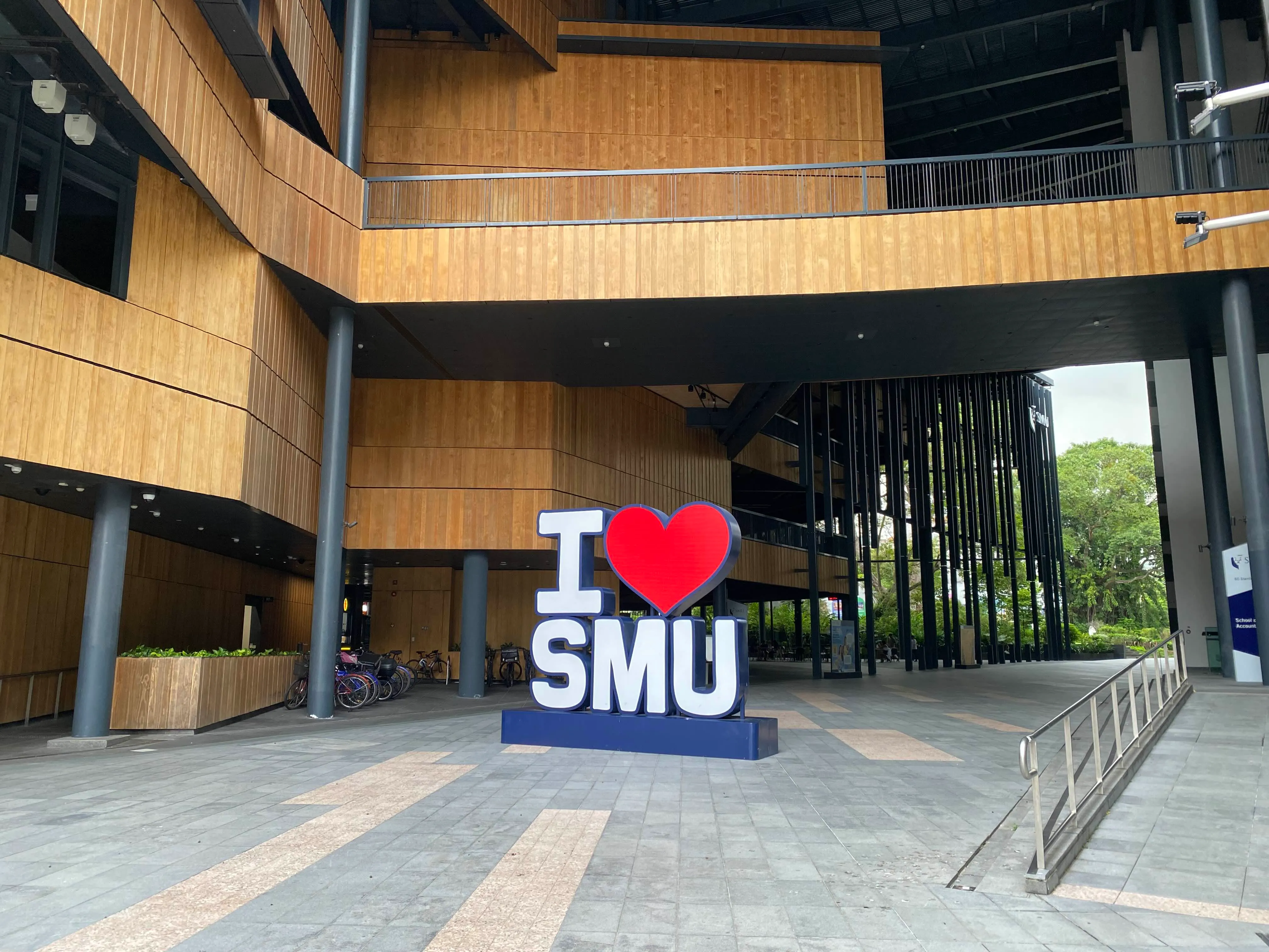 A large blue sign that says I HEART SMU