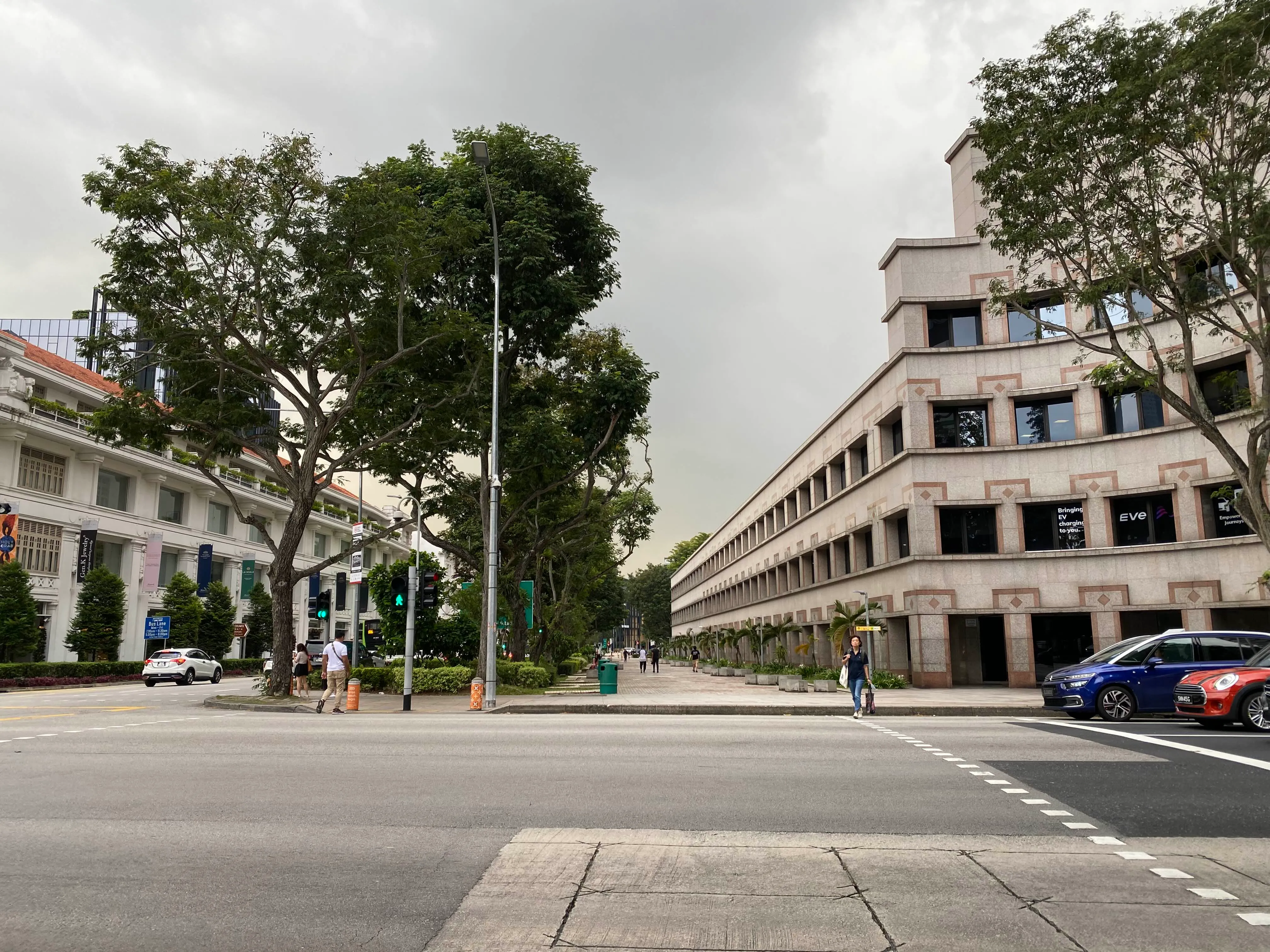 A pedestrian crossing at the traffic light between Raffles City and the ASEAN-Singapore Cybersecurity Centre of Excellence